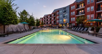 Industrial style swimming pool with shipping container cabanas
